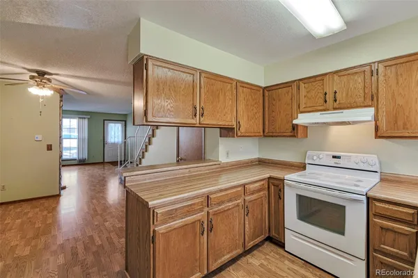 a kitchen with a stove top oven sink and cabinets