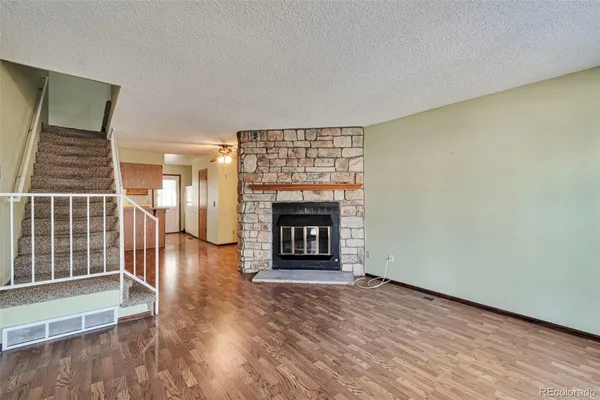 wooden floor in an empty room with a fireplace