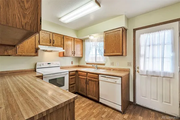 a kitchen with a stove sink and cabinets