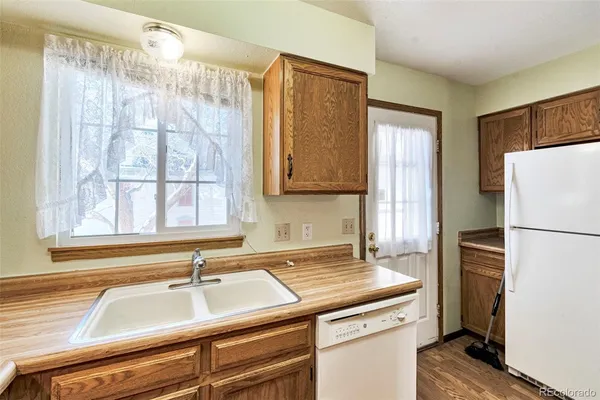 a kitchen with a refrigerator and a sink