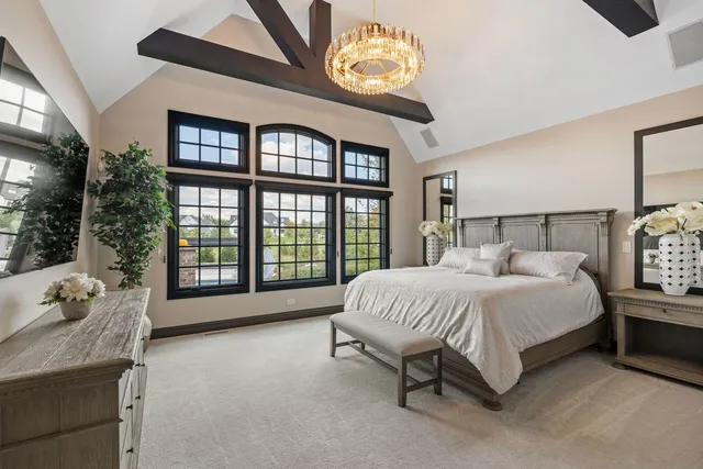 a spacious bedroom with a bed and a large window