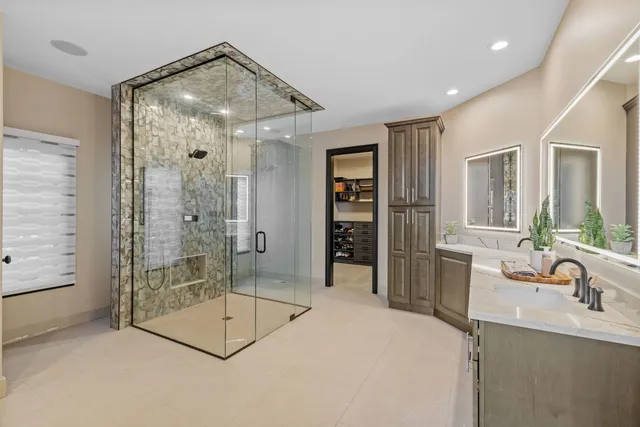 a spacious bathroom with a shower sink and mirror