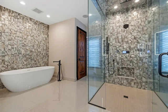 a bathroom with a bathtub and shower