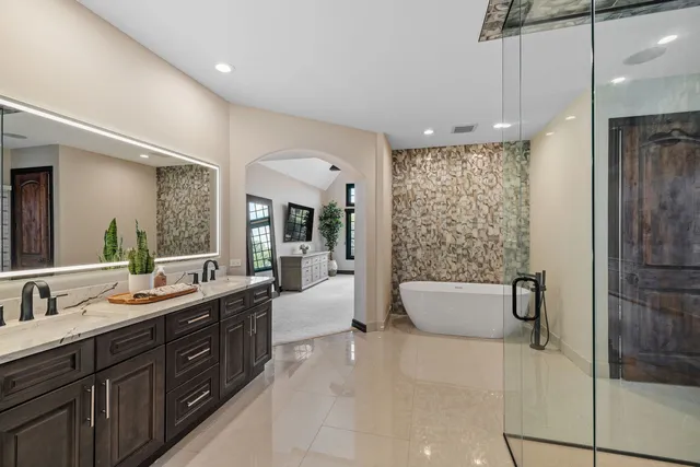 a bathroom with a double vanity sink toilet and shower
