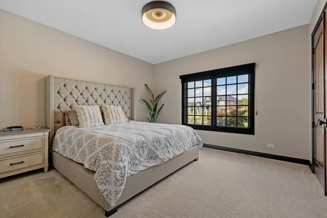 a spacious bedroom with a bed and a window