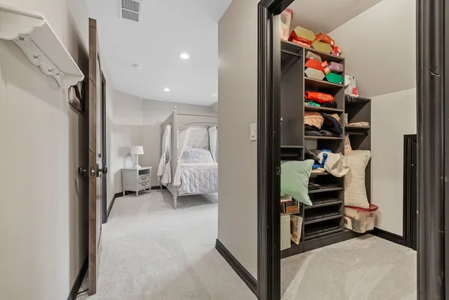 a view of a bedroom with a bed and a window