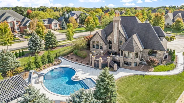 an aerial view of a house with garden space and outdoor seating
