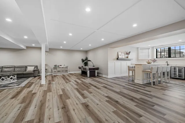 a view of a living room a dining room wooden floor and a window