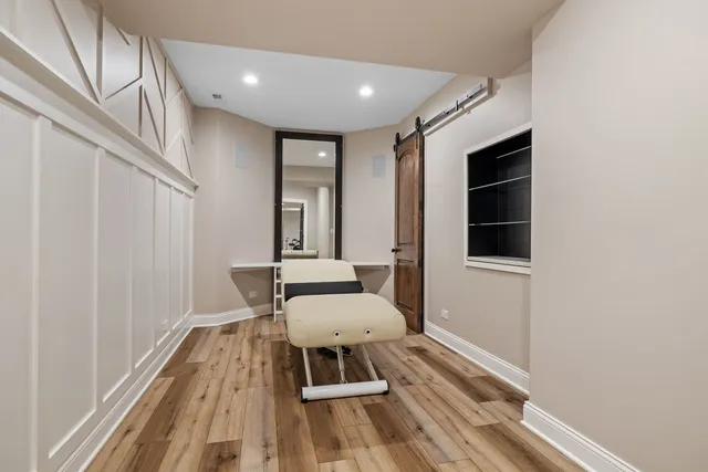 a view of a hallway with wooden floor and staircase