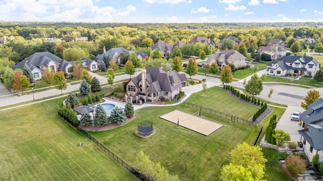 an aerial view of residential house with outdoor space and swimming pool