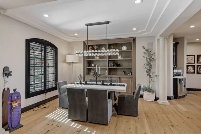 a kitchen with a stove a refrigerator and wooden floor