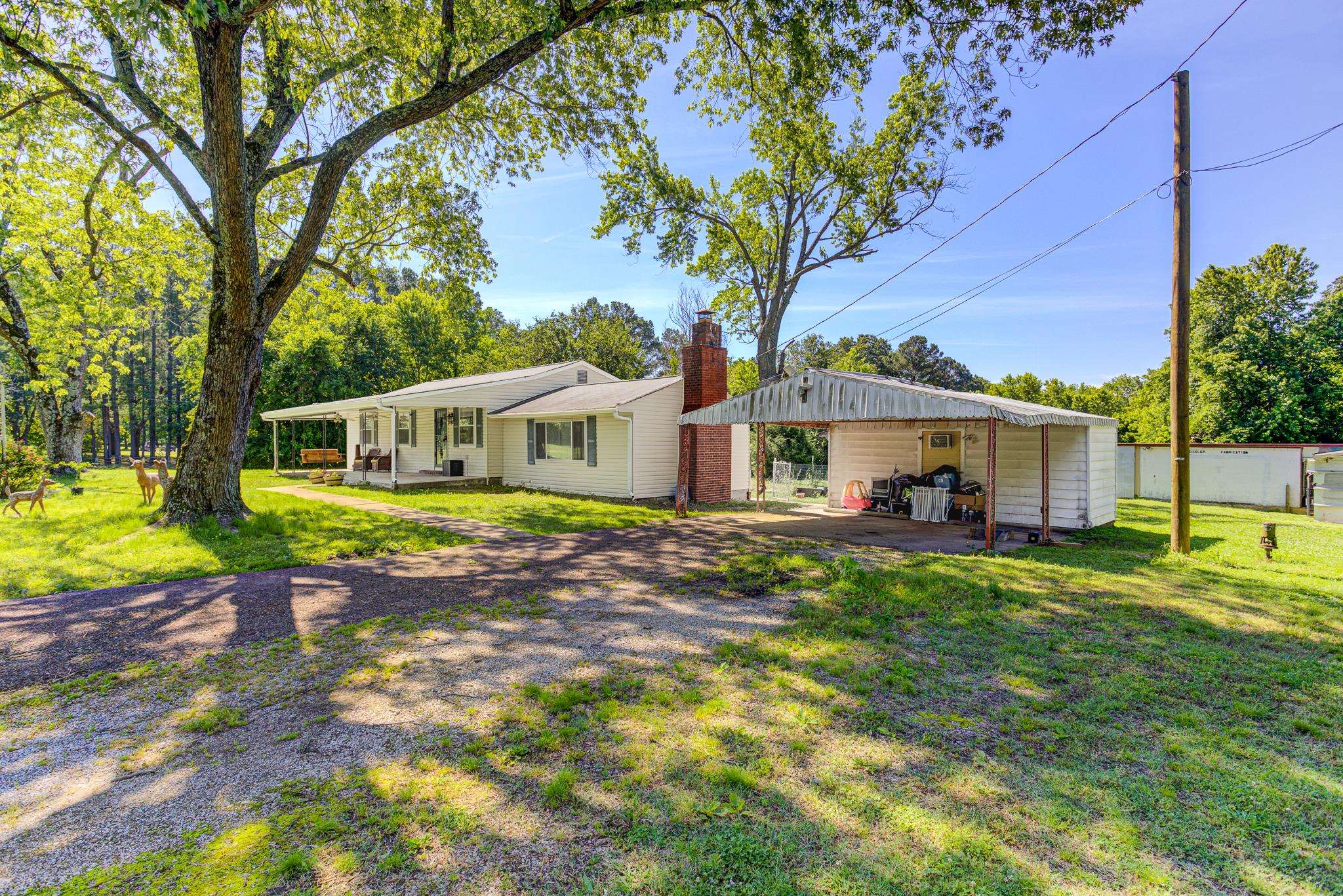 3793 Sykes Road Millington, TN 38053 - Photo 3 of 27 Rear view of property featuring a lawn, a chimney, driveway, a carport, and a porch