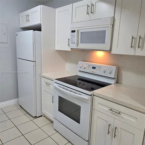 a kitchen with cabinets and stainless steel appliances