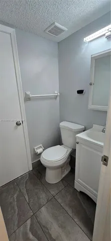 a white toilet sitting next to a bathroom sink