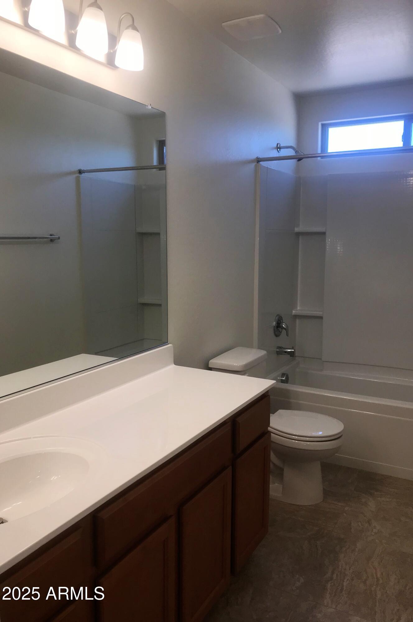 1976 West Rd Agent Street Apache Junction, AZ 85120 - Photo 13 of 15 a bathroom with a sink a toilet and a mirror