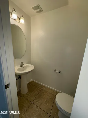 a bathroom with a sink a toilet a mirror and vanity