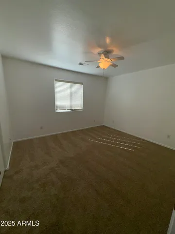 a view of an empty room and a bathroom