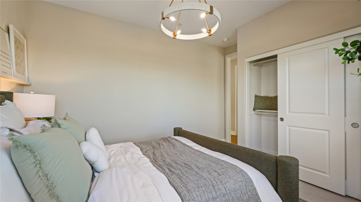 109 Trask Irvine, CA 92618 - Photo 16 of 34 a bedroom with a bed and a chandelier