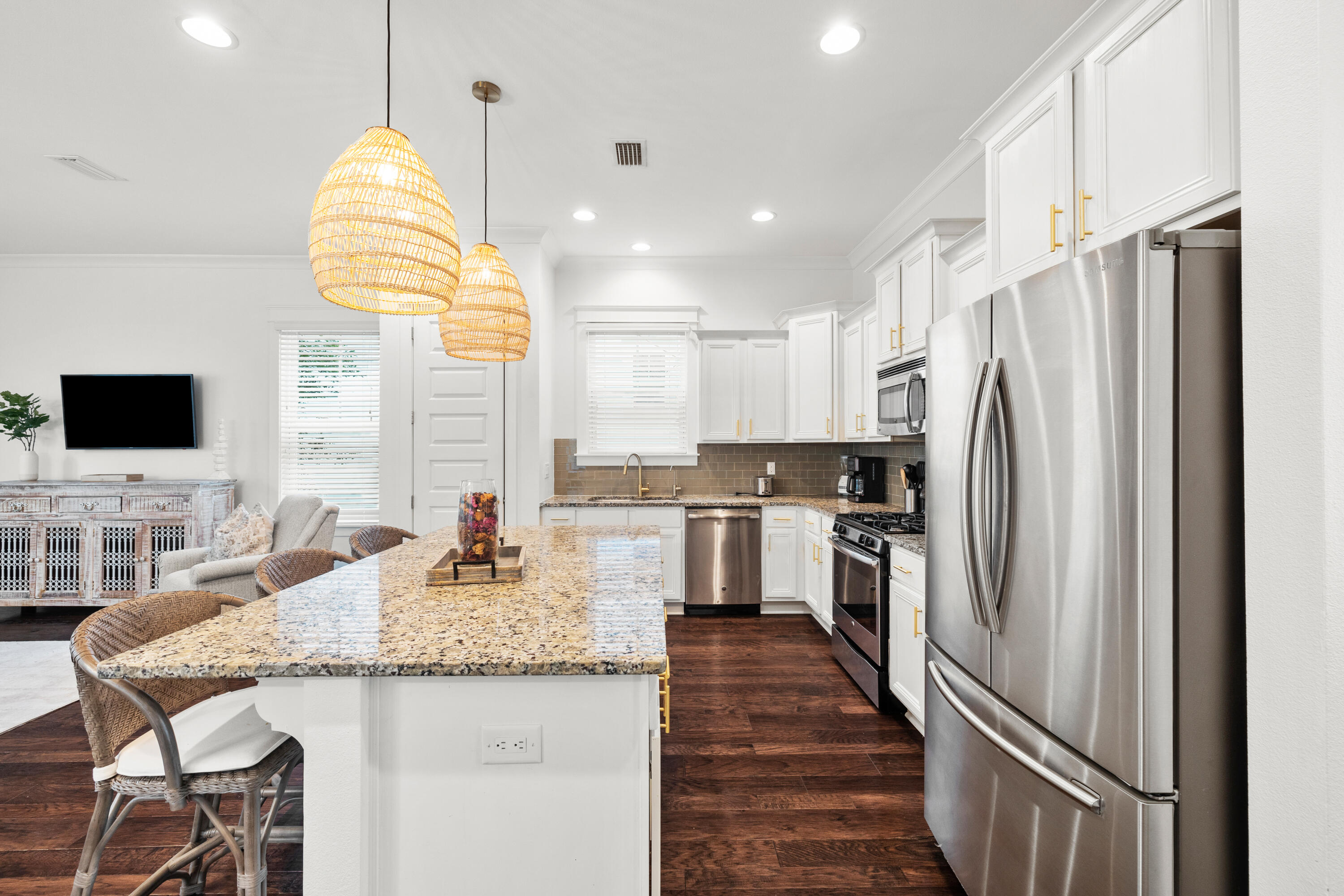 267 Emerald Beach Circle Santa Rosa Beach, FL 32459 - Photo 12 of 59 a kitchen with stainless steel appliances granite countertop a refrigerator a stove a sink and a dining table with wooden floor