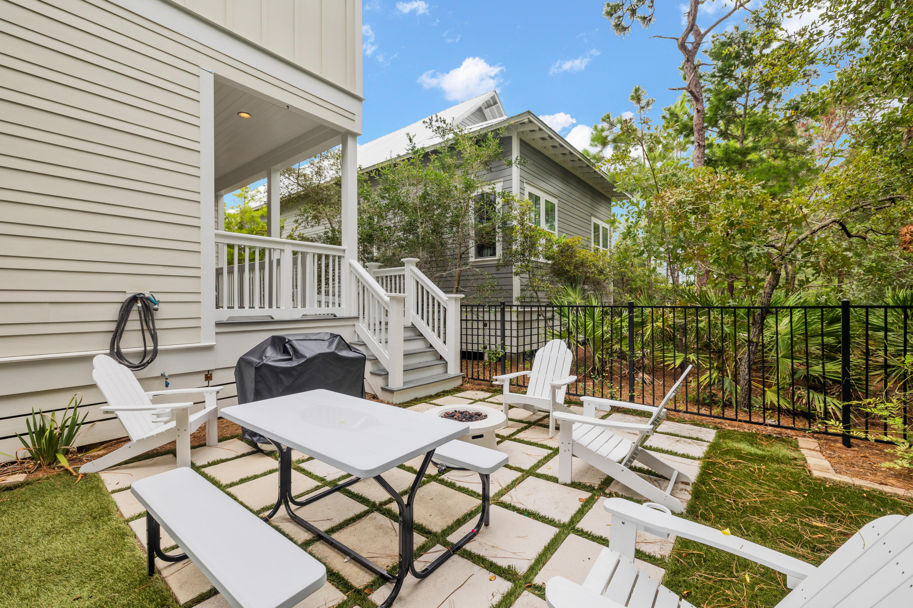 267 Emerald Beach Circle Santa Rosa Beach, FL 32459 - Photo 50 of 59 a view of a patio with a dining table and chairs with wooden floor