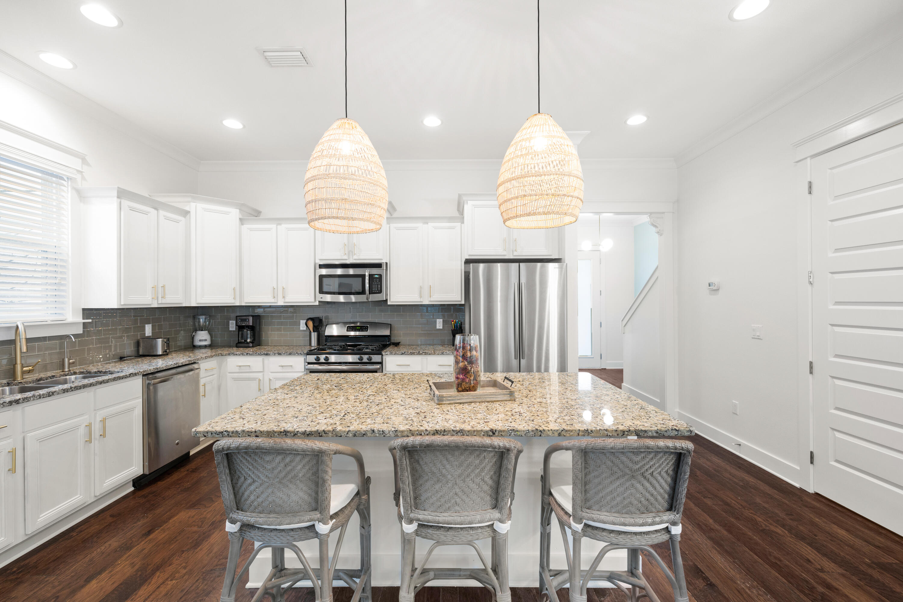 267 Emerald Beach Circle Santa Rosa Beach, FL 32459 - Photo 10 of 59 a kitchen with granite countertop white cabinets and stainless steel appliances