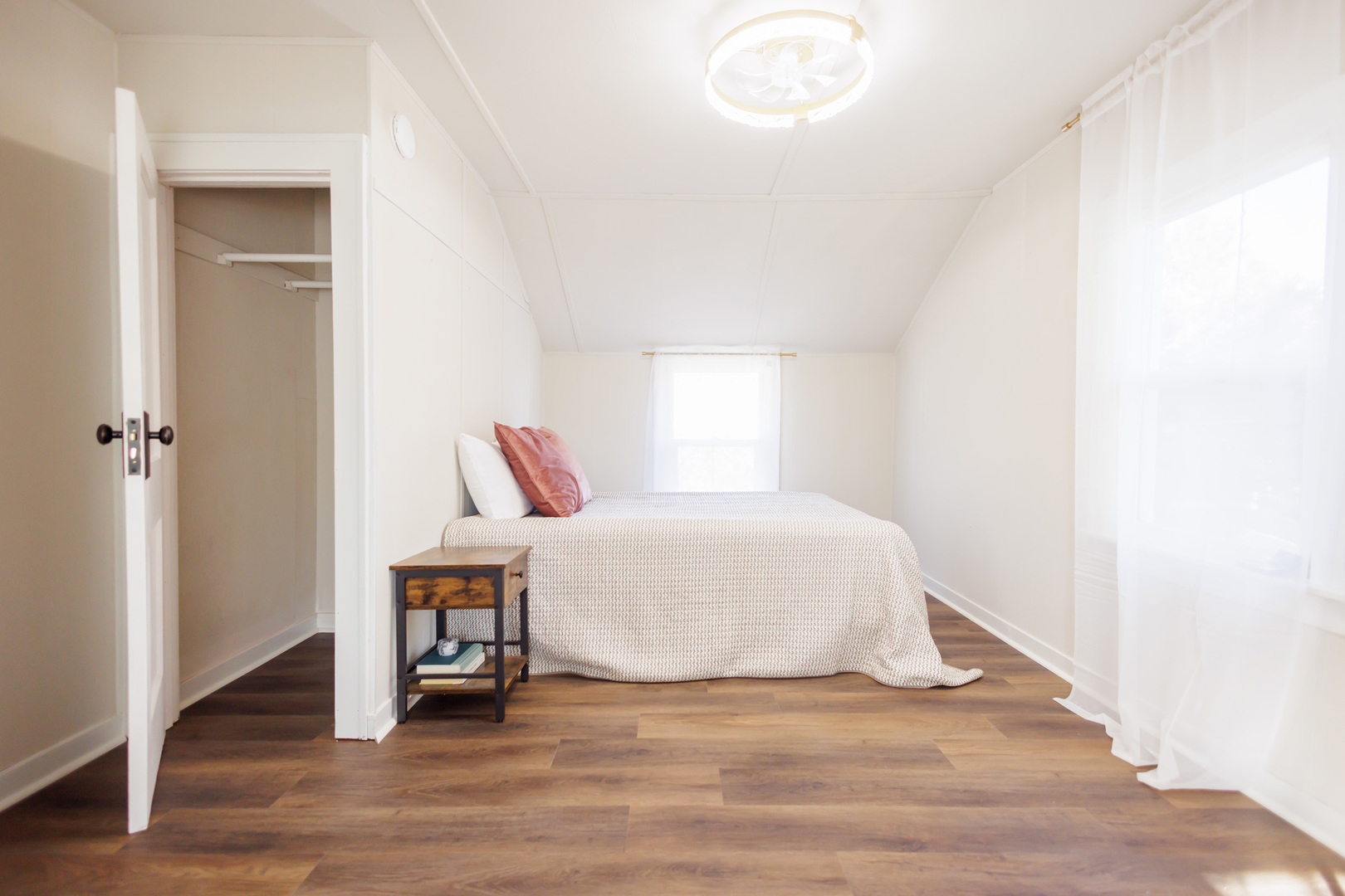 1240 West Merchant Street Kankakee, IL 60901 - Photo 14 of 25 a white bed sitting in a bedroom next to a window and wooden floor