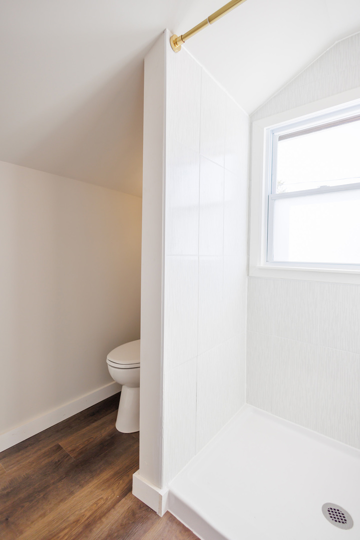 1240 West Merchant Street Kankakee, IL 60901 - Photo 17 of 25 a white toilet sitting next to a shower
