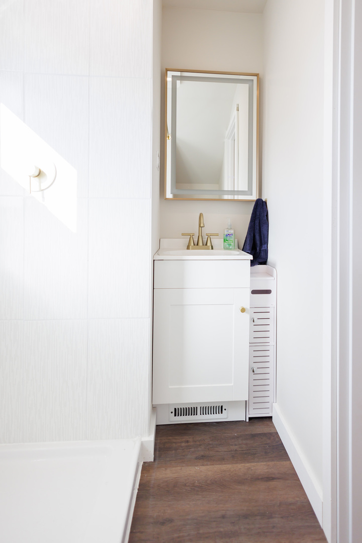 1240 West Merchant Street Kankakee, IL 60901 - Photo 18 of 25 a bathroom with a sink and a mirror