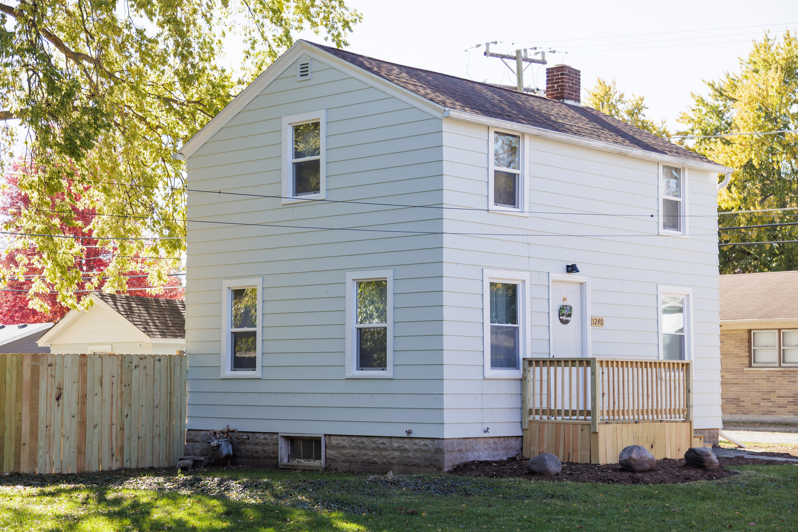 1240 West Merchant Street Kankakee, IL 60901 - Photo 2 of 25 a front view of a house with a yard