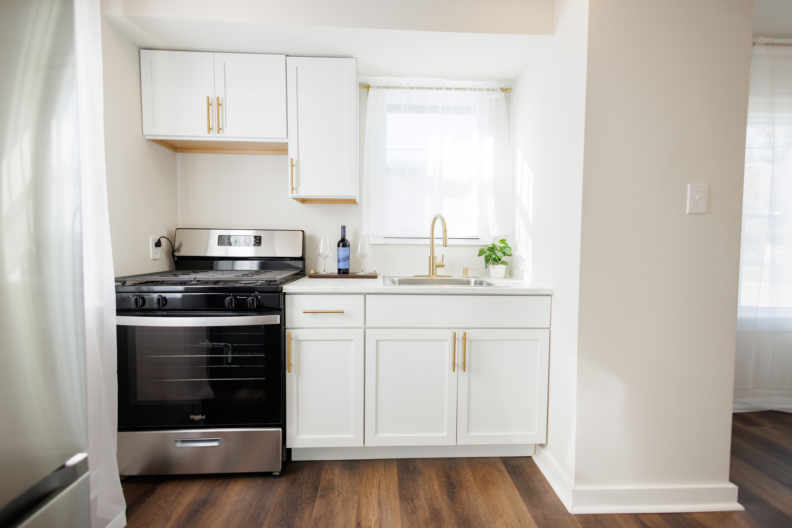 1240 West Merchant Street Kankakee, IL 60901 - Photo 10 of 25 a kitchen with white cabinets and appliances