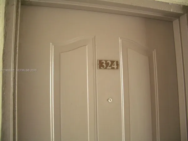 a view of room that has a door and a window