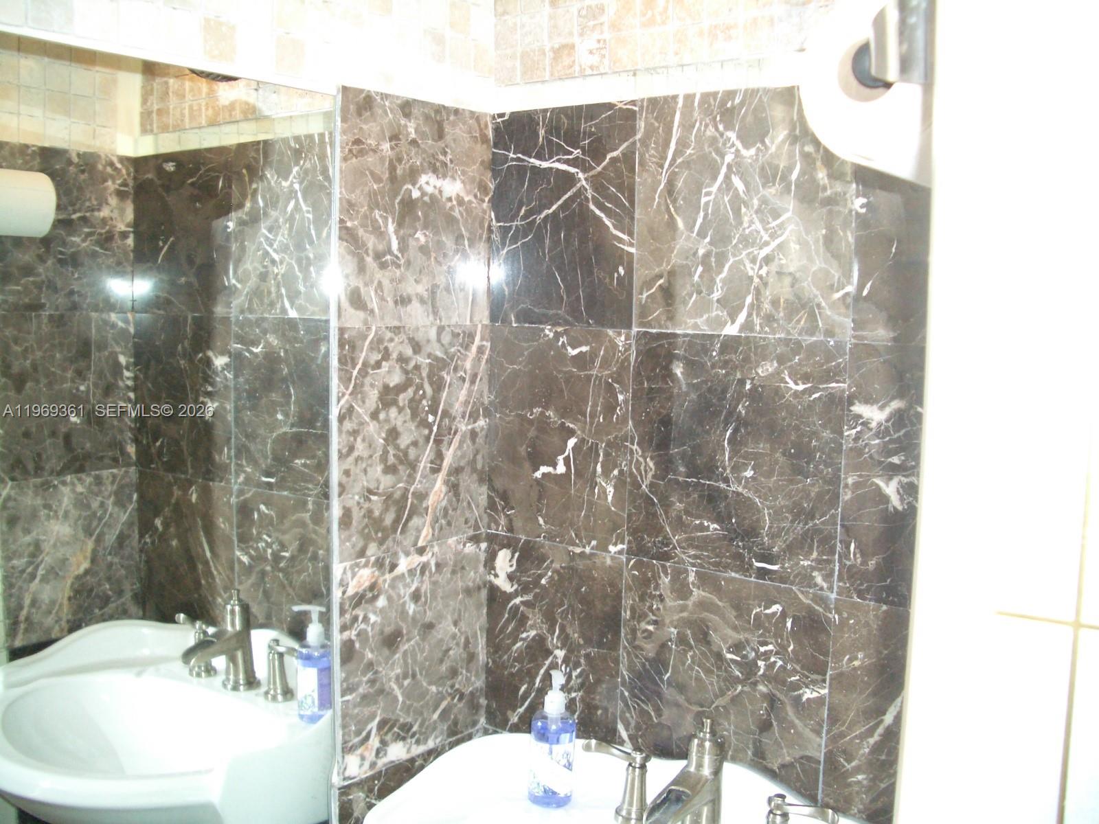 10900 Southwest 104th Street, Unit 324 Miami, FL 33176 - Photo 21 of 34 a bathroom with a sink toilet and shower