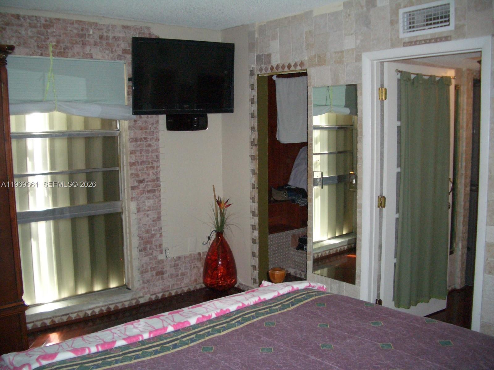 10900 Southwest 104th Street, Unit 324 Miami, FL 33176 - Photo 30 of 34 a living room with furniture and a flat screen tv