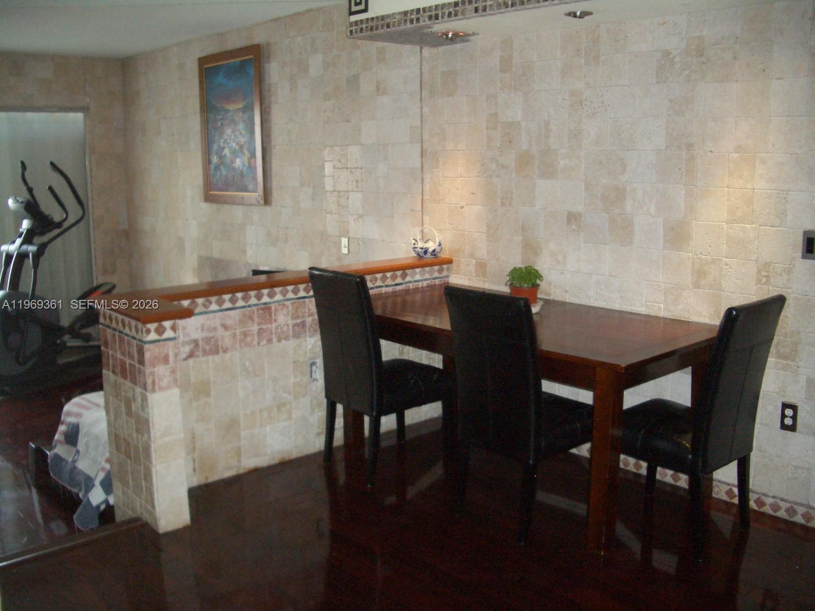 10900 Southwest 104th Street, Unit 324 Miami, FL 33176 - Photo 3 of 34 a view of a dining room with furniture and wooden floor