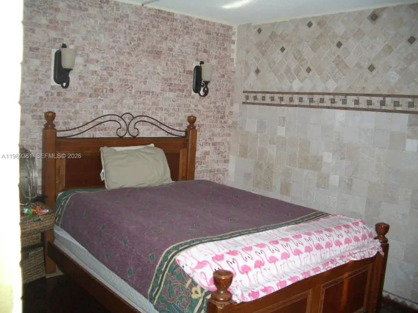 a bedroom with a bed and a mirror