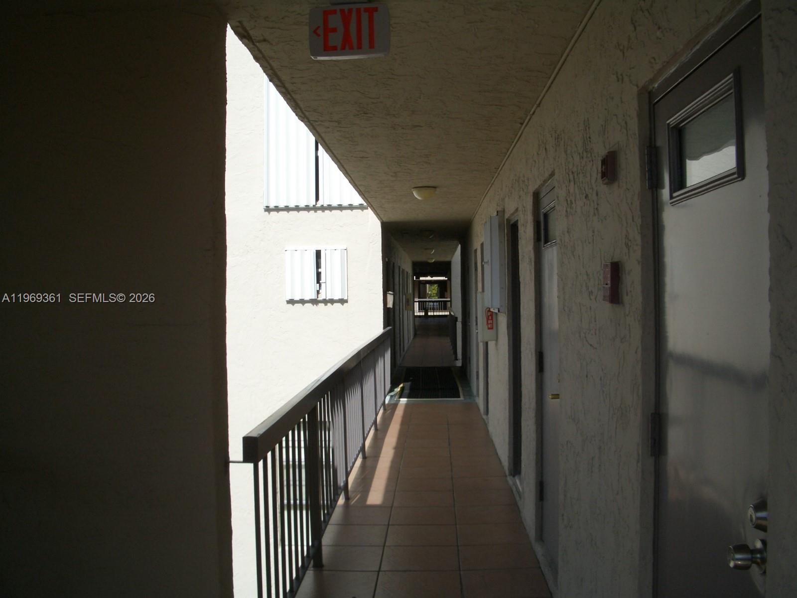 10900 Southwest 104th Street, Unit 324 Miami, FL 33176 - Photo 6 of 34 a view of a hallway with wooden floor and staircase
