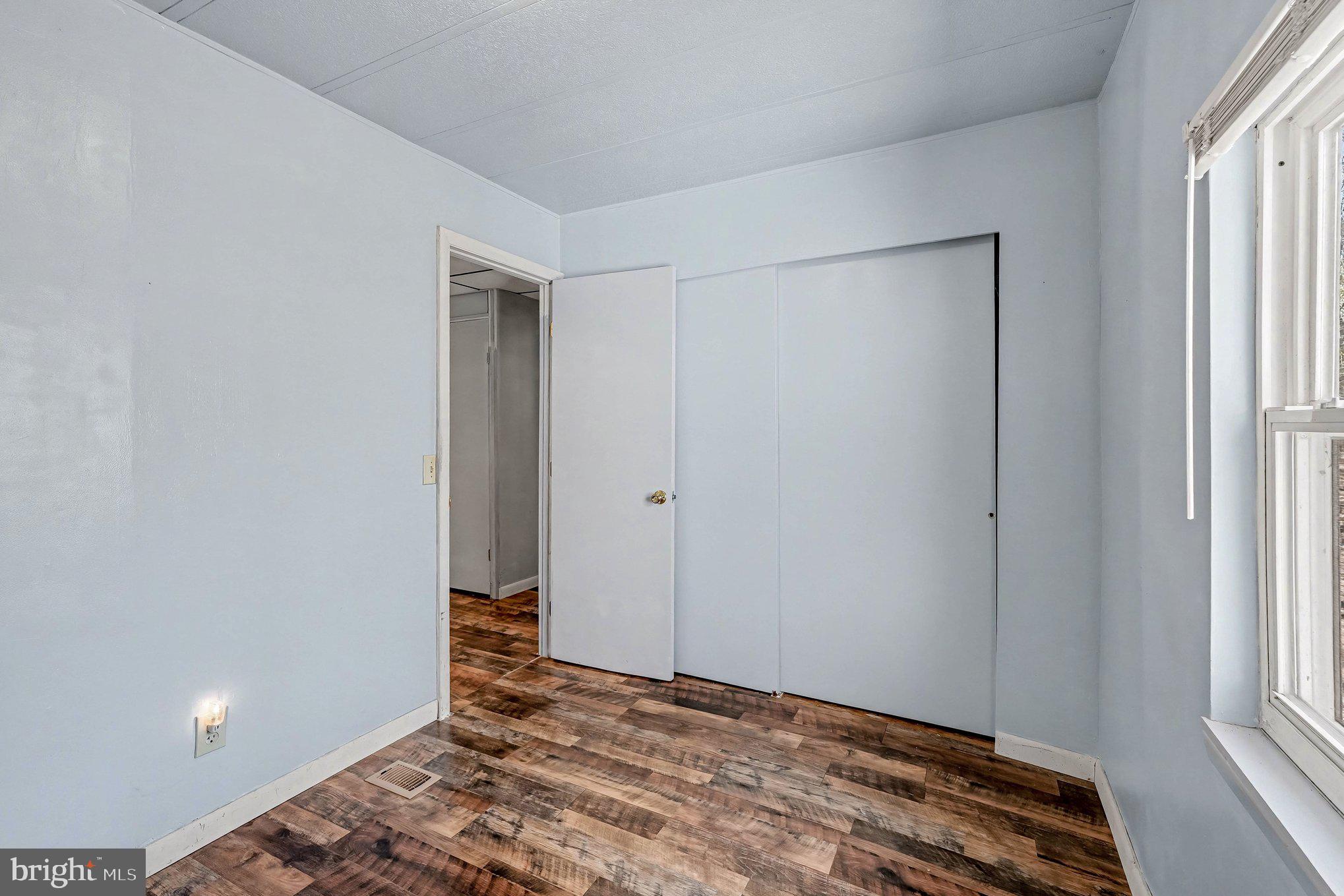 3440 Van Buren Road Burr Hill, VA 22433 - Photo 16 of 24 a view of room with window and wooden floor