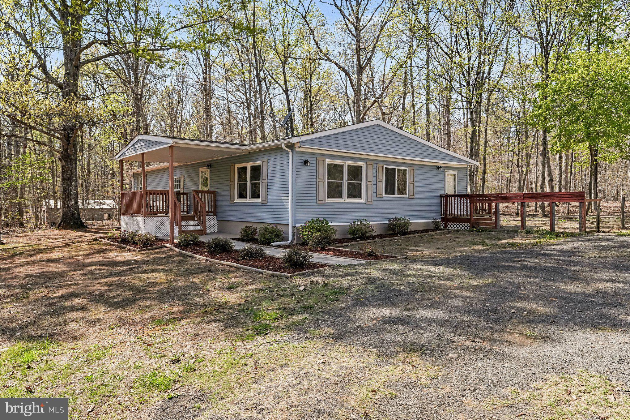 3440 Van Buren Road Burr Hill, VA 22433 - Photo 3 of 24 a front view of a house with a garden