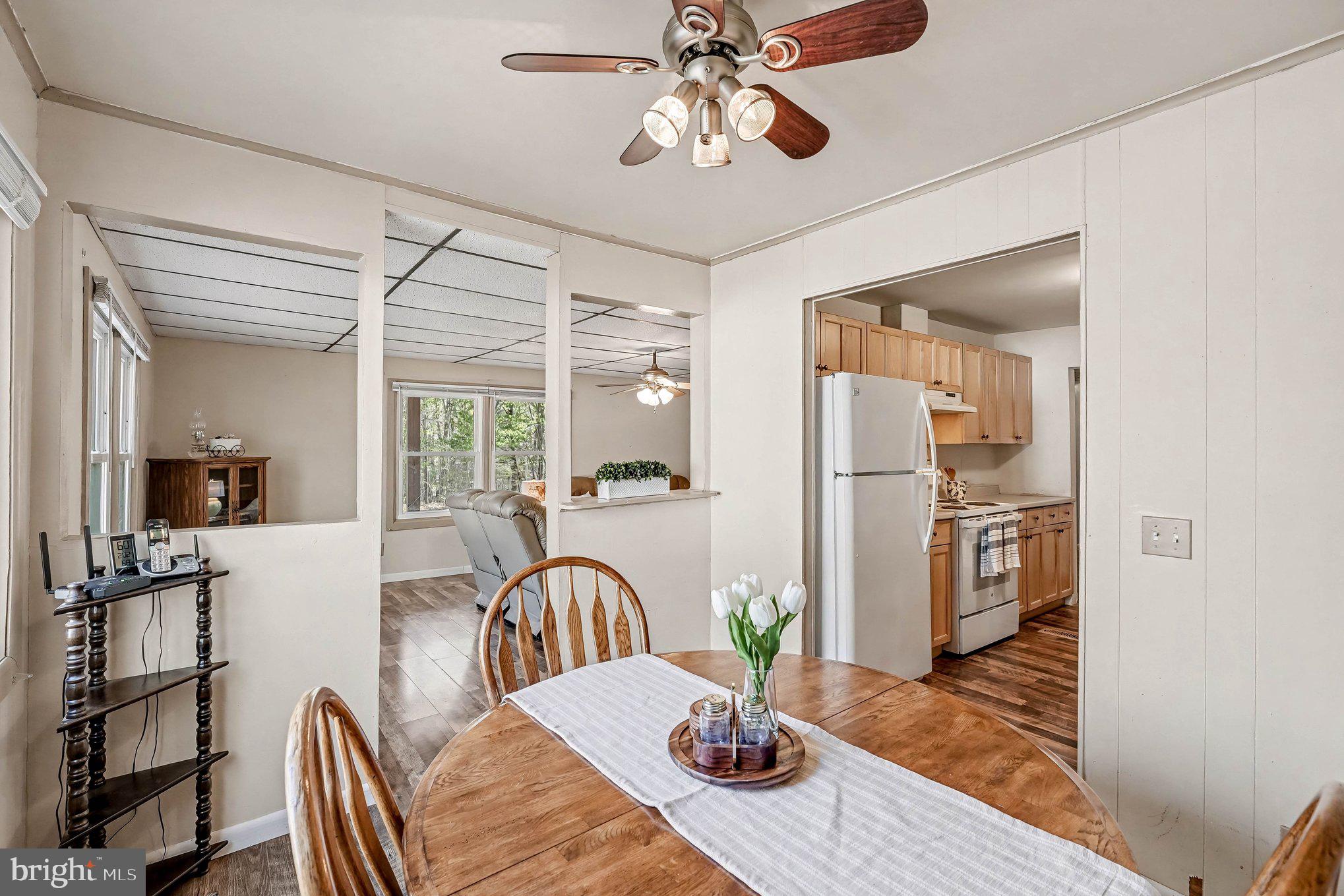 3440 Van Buren Road Burr Hill, VA 22433 - Photo 9 of 24 a view of a dining room with furniture a chandelier and wooden floor