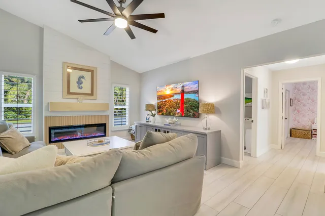 a living room with furniture a fireplace and a flat screen tv