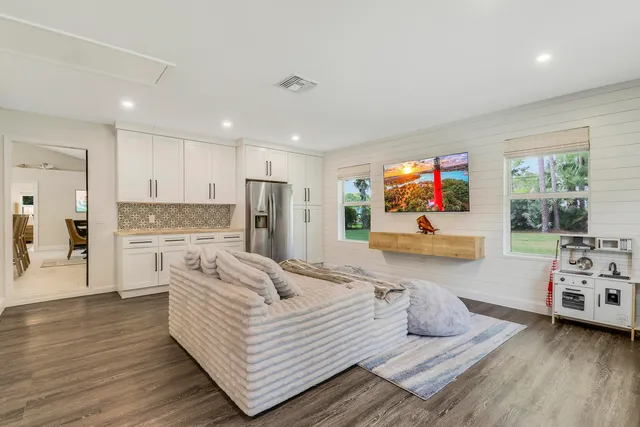 a large bedroom with a bed and a large window