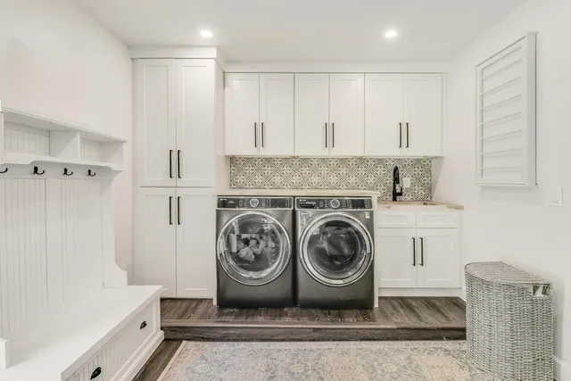 a living room with furniture a table and a floor to ceiling window
