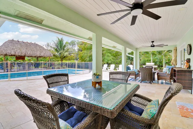 a view of yard with swimming pool and furniture