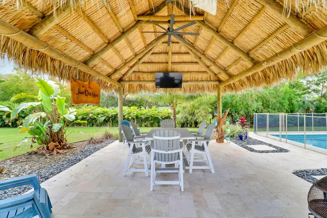 a view of a house with swimming pool and sitting area