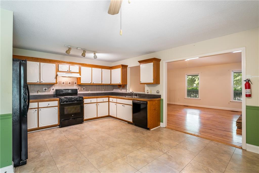 90 Chimney Sweep Trail Fairmount, GA 30139 - Photo 21 of 42 a large kitchen with stainless steel appliances granite countertop a stove and a sink