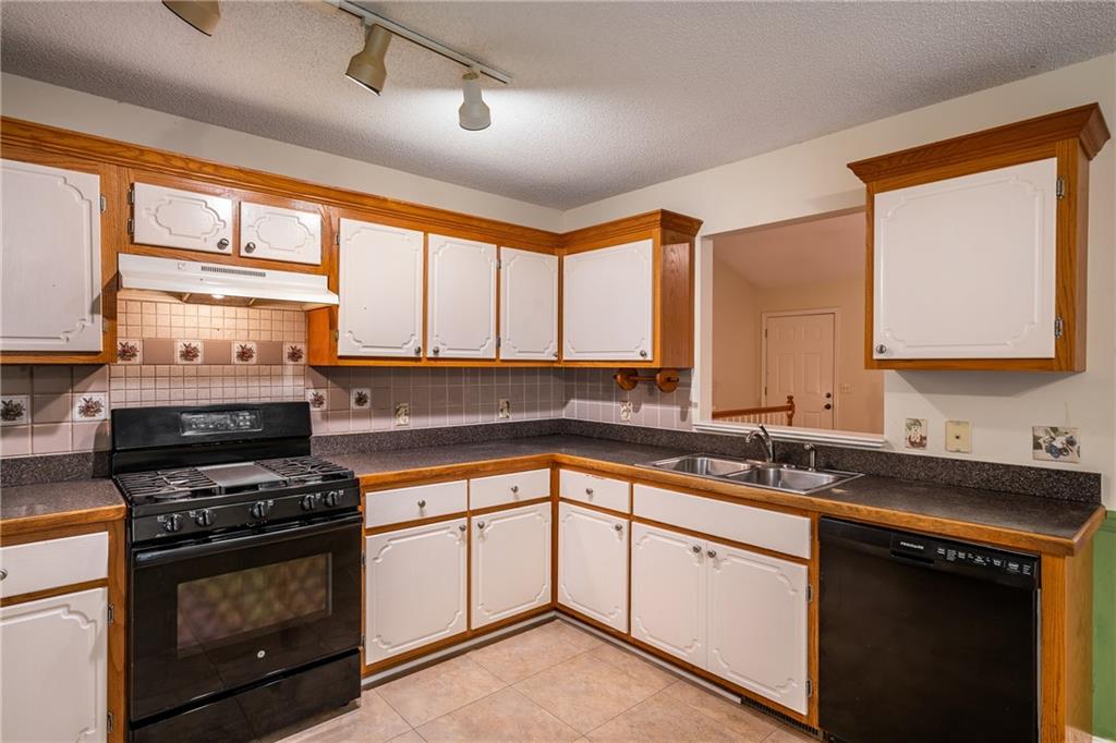 90 Chimney Sweep Trail Fairmount, GA 30139 - Photo 25 of 42 a kitchen with a sink stove top oven and cabinets