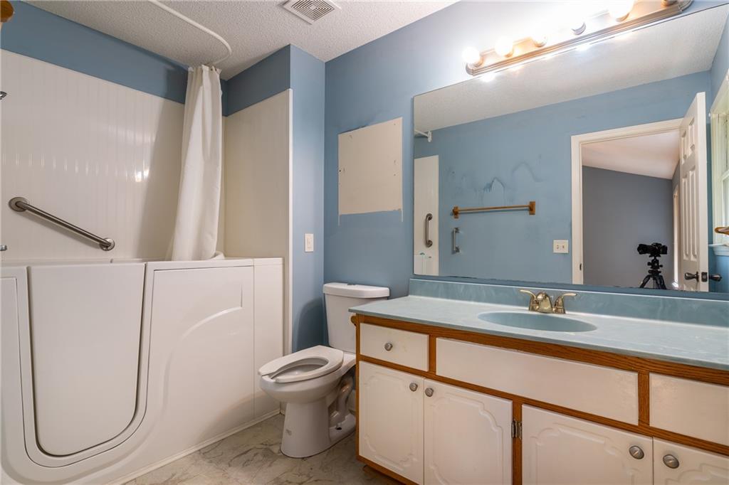 90 Chimney Sweep Trail Fairmount, GA 30139 - Photo 28 of 42 a bathroom with a sink and mirror with toilet