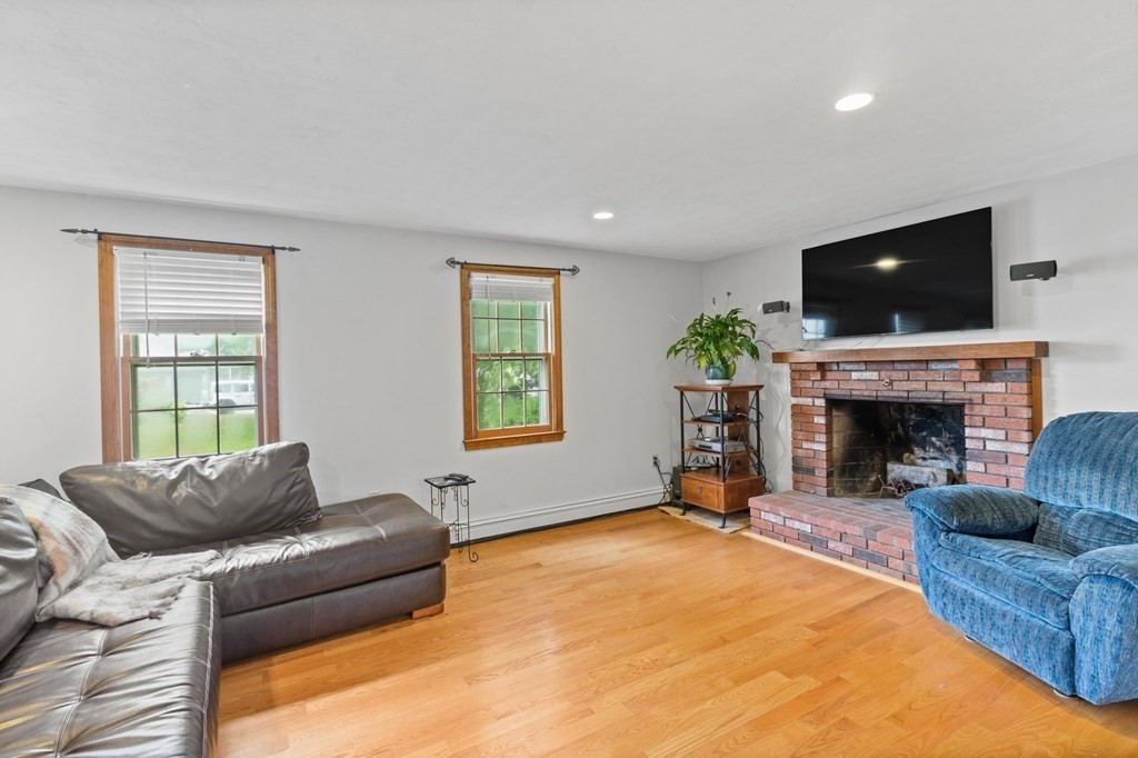 45 Leonard Road Marshfield, MA 02050 - Photo 11 of 20 a living room with furniture a flat screen tv and a fireplace