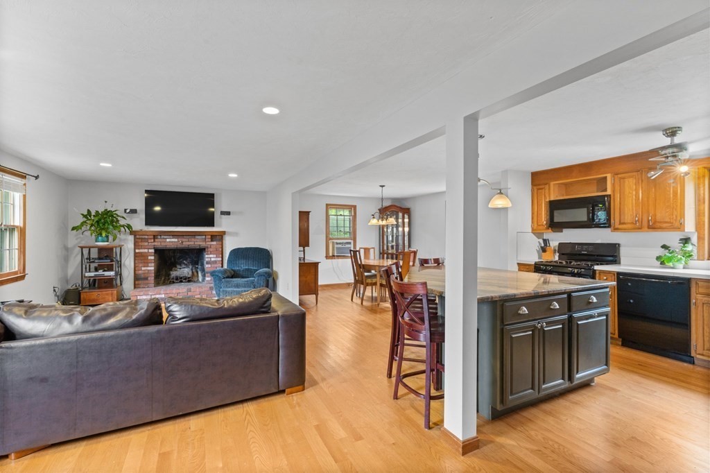 45 Leonard Road Marshfield, MA 02050 - Photo 12 of 20 a living room with furniture a fireplace and a kitchen view