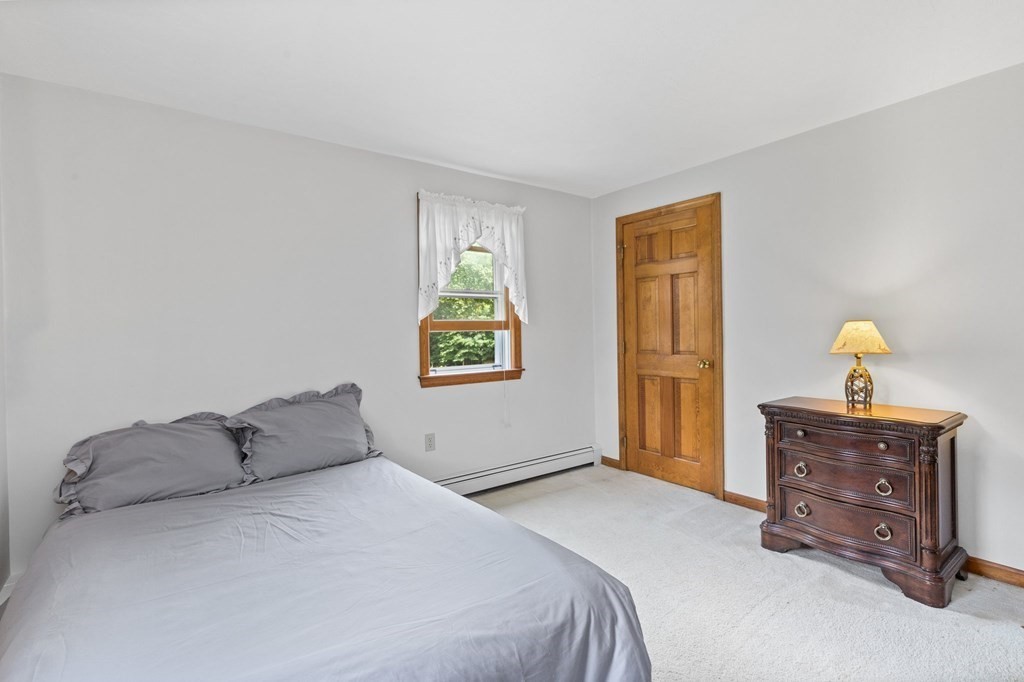 45 Leonard Road Marshfield, MA 02050 - Photo 19 of 20 a bedroom with a bed and painting on the wall